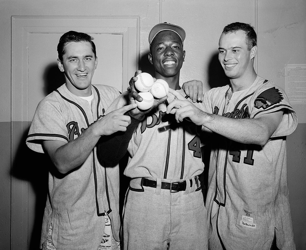The long-ball hitters who contributed to Milwaukee's 13-hit attack against the Brooklyn Dodgers in 1956: Johnny Logan, Hank Aaron, and Eddie Mathews