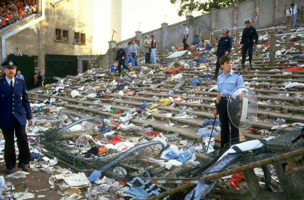 Workers clear the debris at Heysel Stadium after the European Cup final. | David Cannon/Allsport/Getty Images