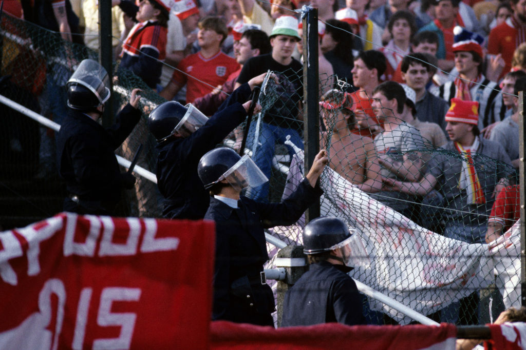 Belgian police officers try to repair the fence separating fans from Juventus and Liverpool. | Peter Robinson - PA Images via Getty Images