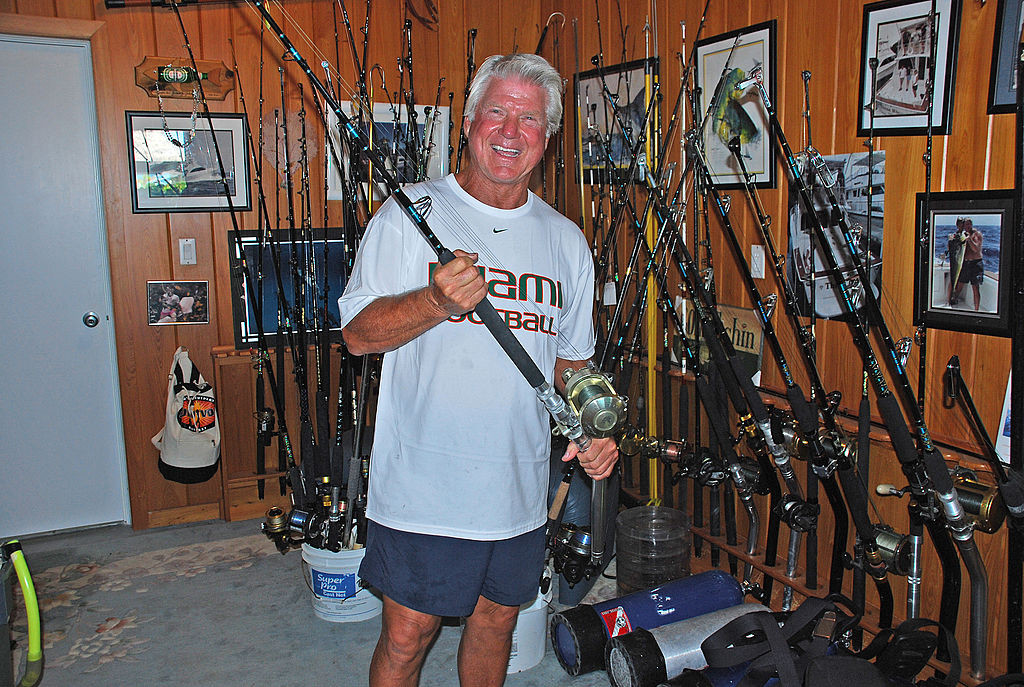 Jimmy Johnson posing with all of his fishing equipment