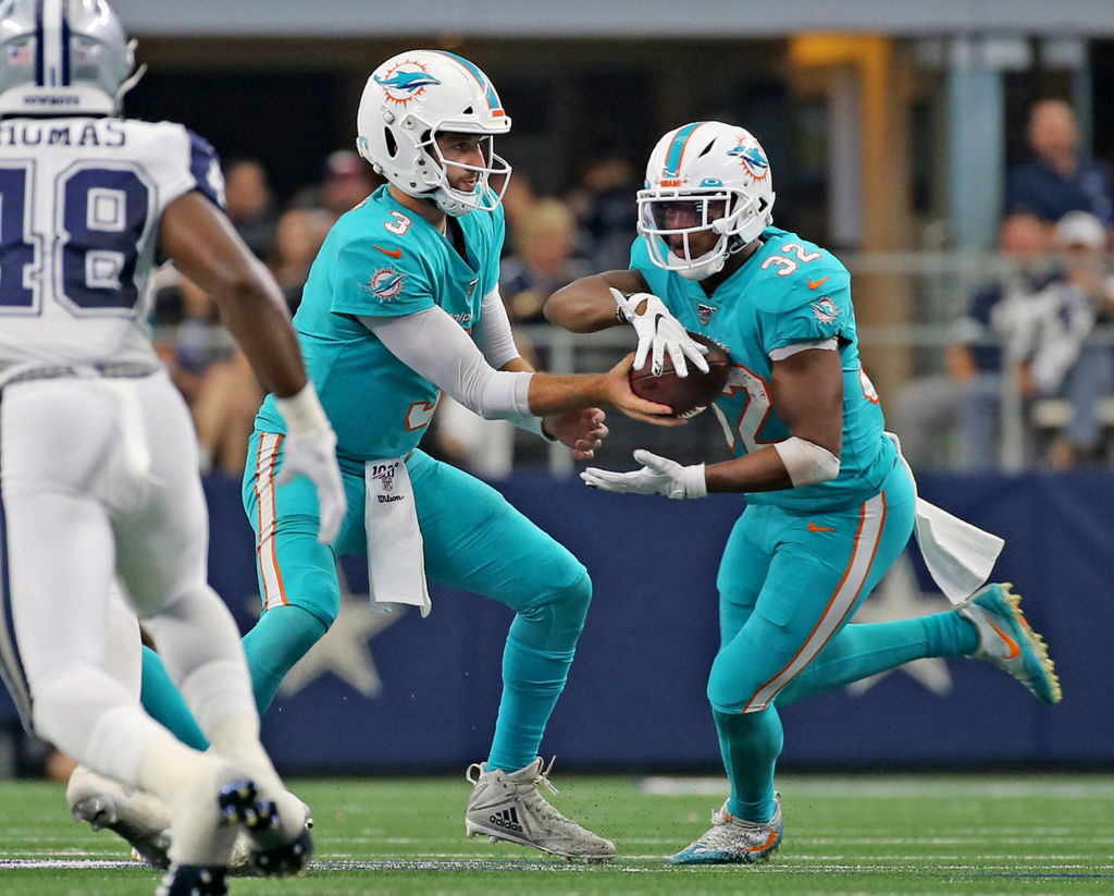 Miami Dolphins running back Kenyan Drake takes the ball from quarterback Josh Rosen