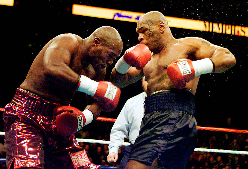 Mike Tyson (R) knocks out Clifford Etienne 49 seconds into the first round