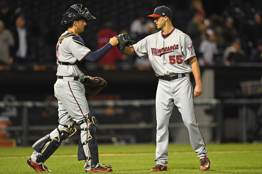 Minnesota Twins catcher Jason Castro (L) and Minnesota Twins relief pitcher Taylor Rogers