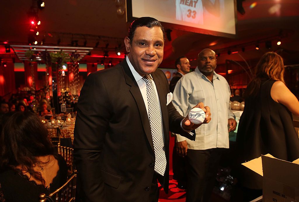Sammy Sosa holding a baseball at a charity event