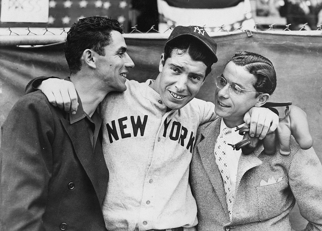 Rookie Joe DiMaggio (C) hugs his brothers Vince (L) and Dom before the start of the 1936 World Series