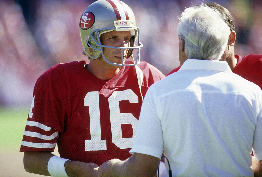 Joe Montana and Bill Walsh talking on the sideline