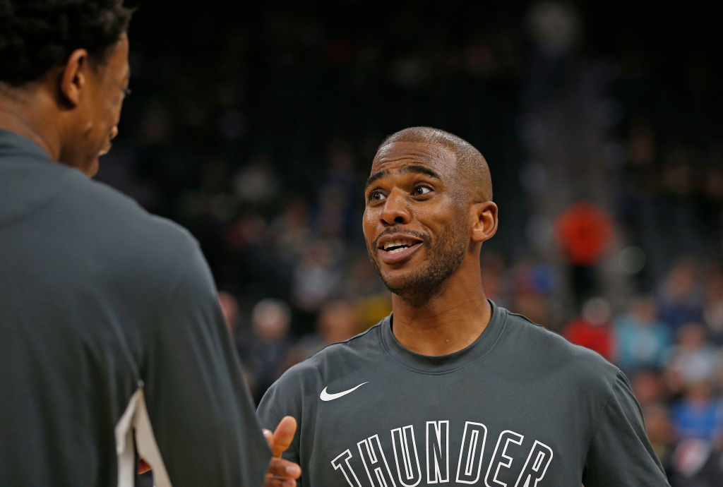 Chris Paul of the Oklahoma City Thunder chats with teammates