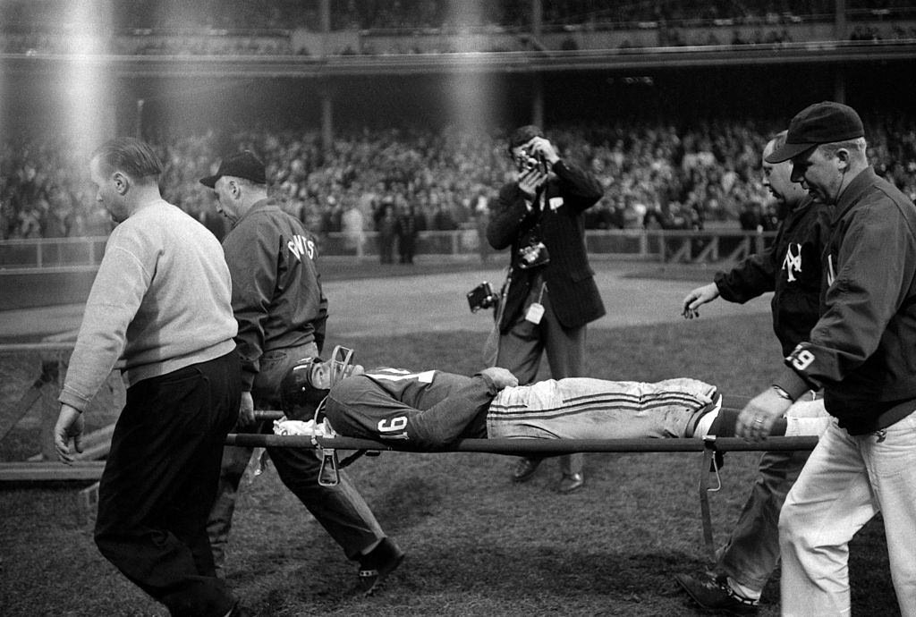Frank Gifford is carried off the field on a stretcher after being hit by Eagles linebacker Chuck Bednarik