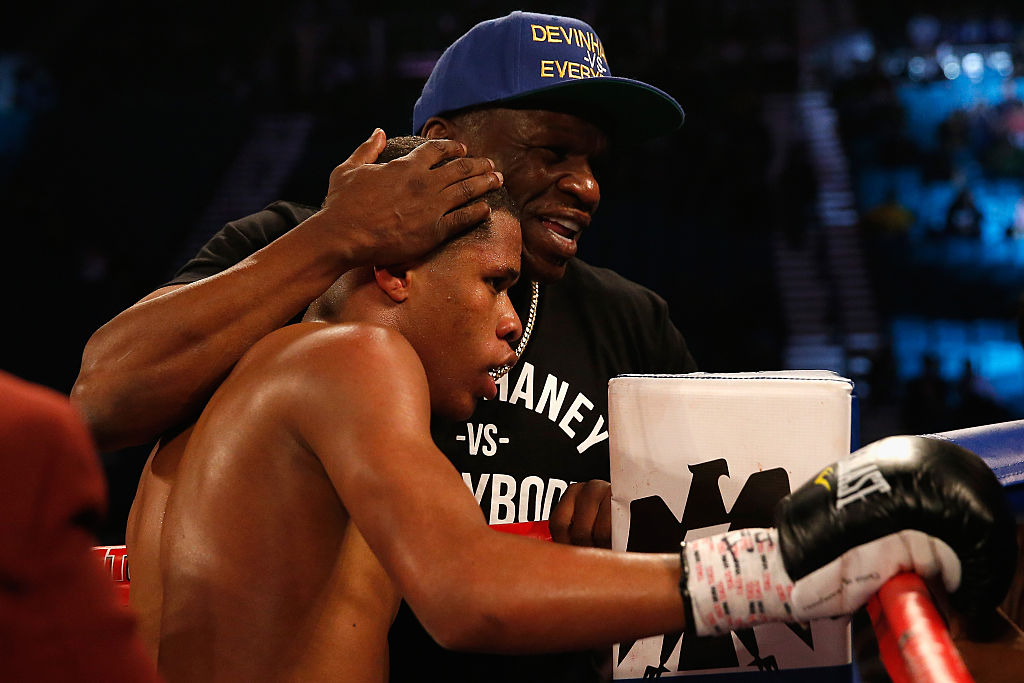 Devin Haney celebrates with his trainer Floyd Mayweather Sr. after Haney's victory