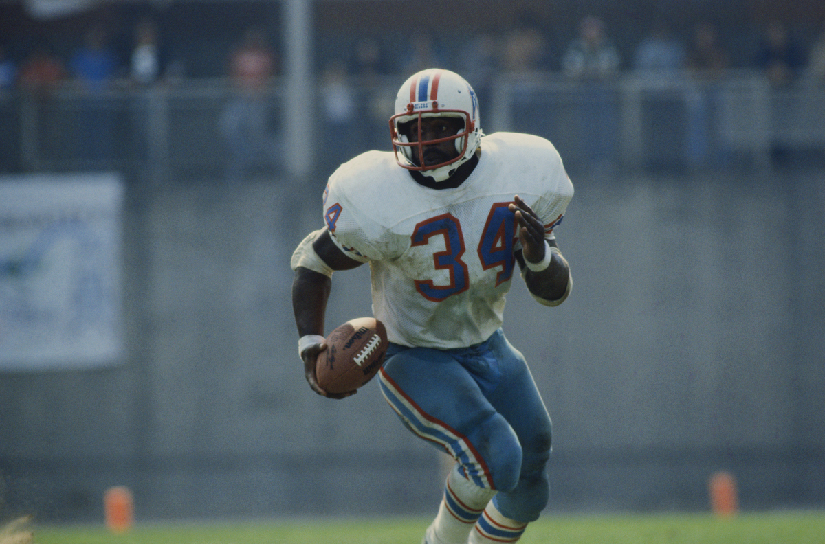 Earl Campbell runs with the football