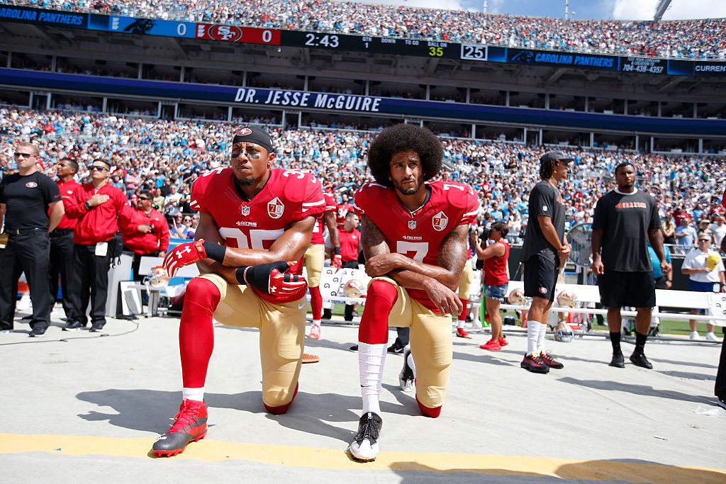 Eric Reid and Colin Kaepernick kneeling together in a stadium
