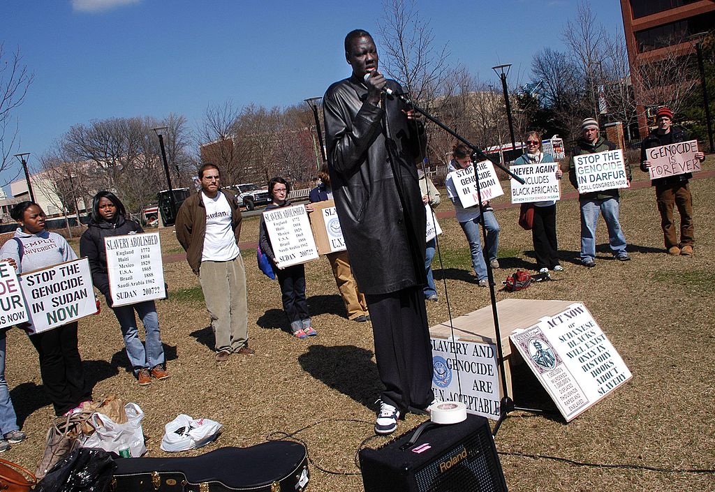 Former NBA star, Manute Bol, speaks as he and other Sudanese natives participate in a 2006 rally for action to end the violence in Sudan