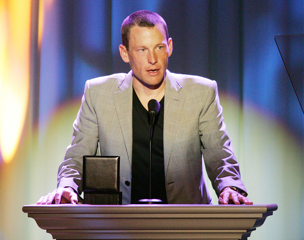 Lance Armstrong standing at a podium after winning an award