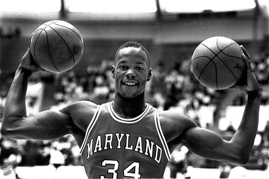 Len Bias holding two basketballs while posing for a photo