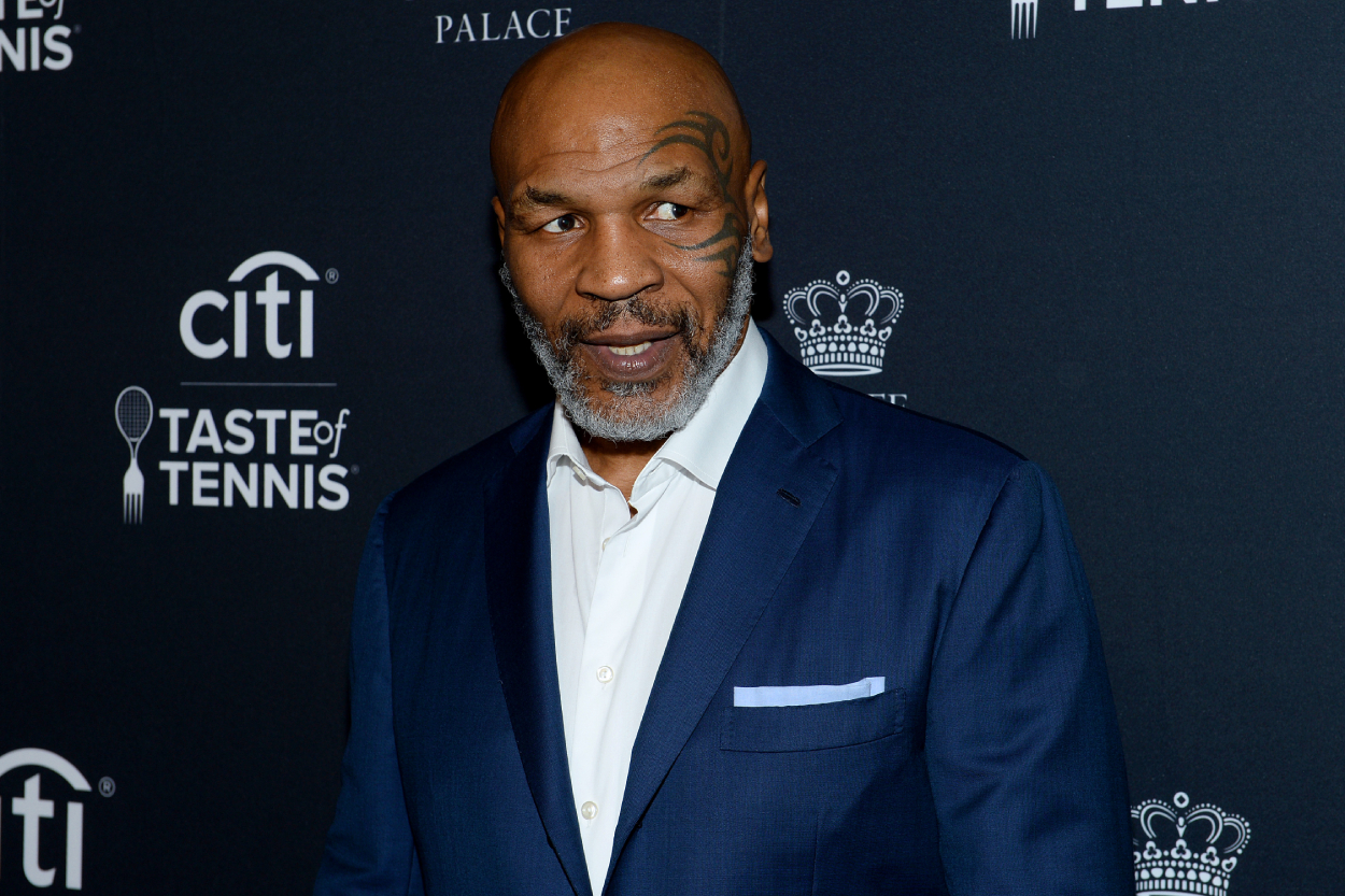 Mike Tyson wearing a blue suit at a charity event