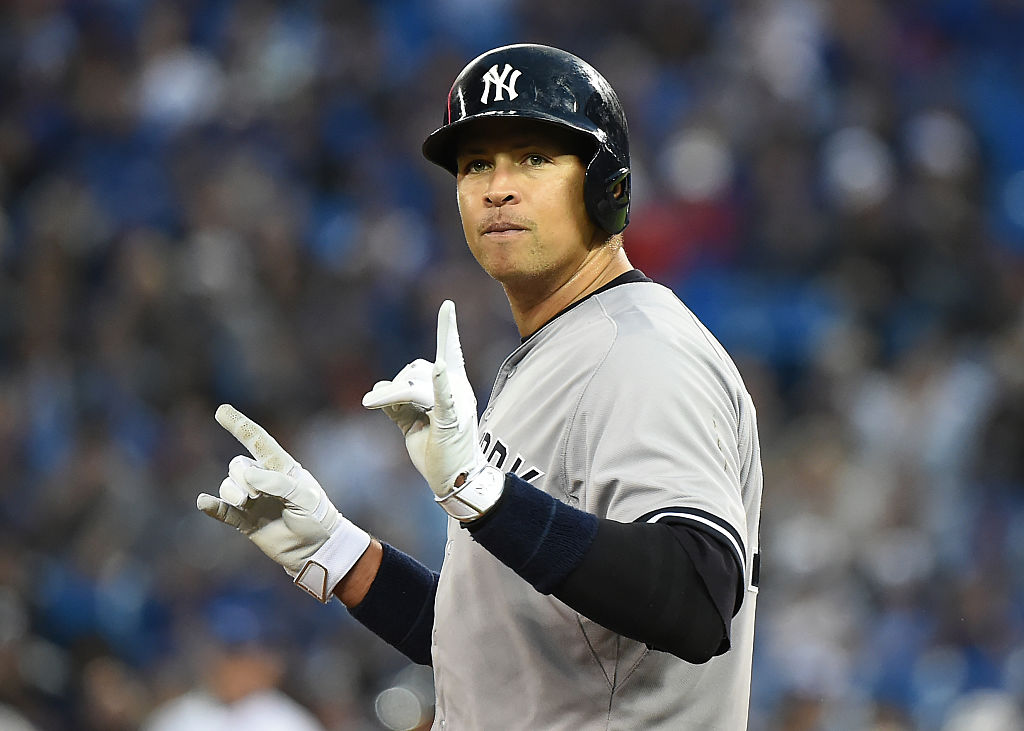 Yankees designated hitter Alex Rodriguez gestures after reaching third base