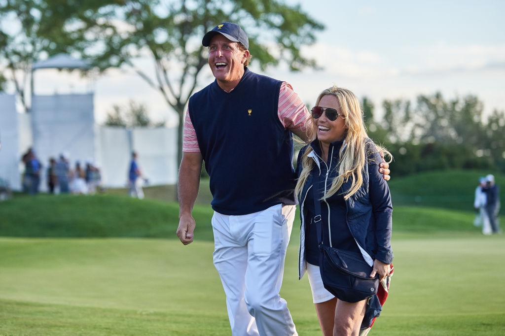 Phil Mickelson smiles and walks with his wife Amy in 2017