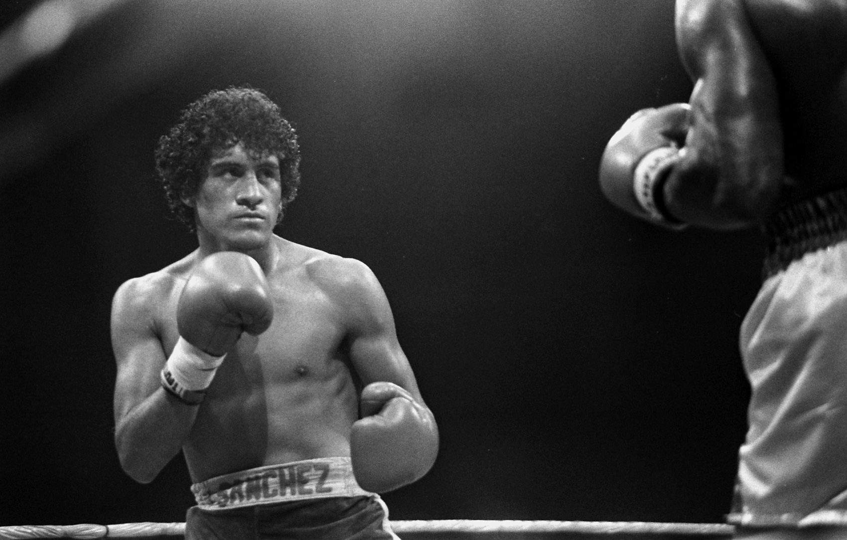 Star boxer Salvador Sanchez holds his fists up in the boxing ring