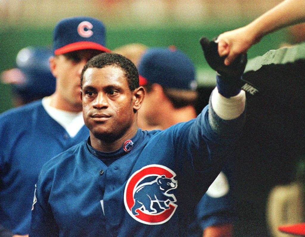 Sammy Sosa high fives a teammate during his Chicago Cubs playing days