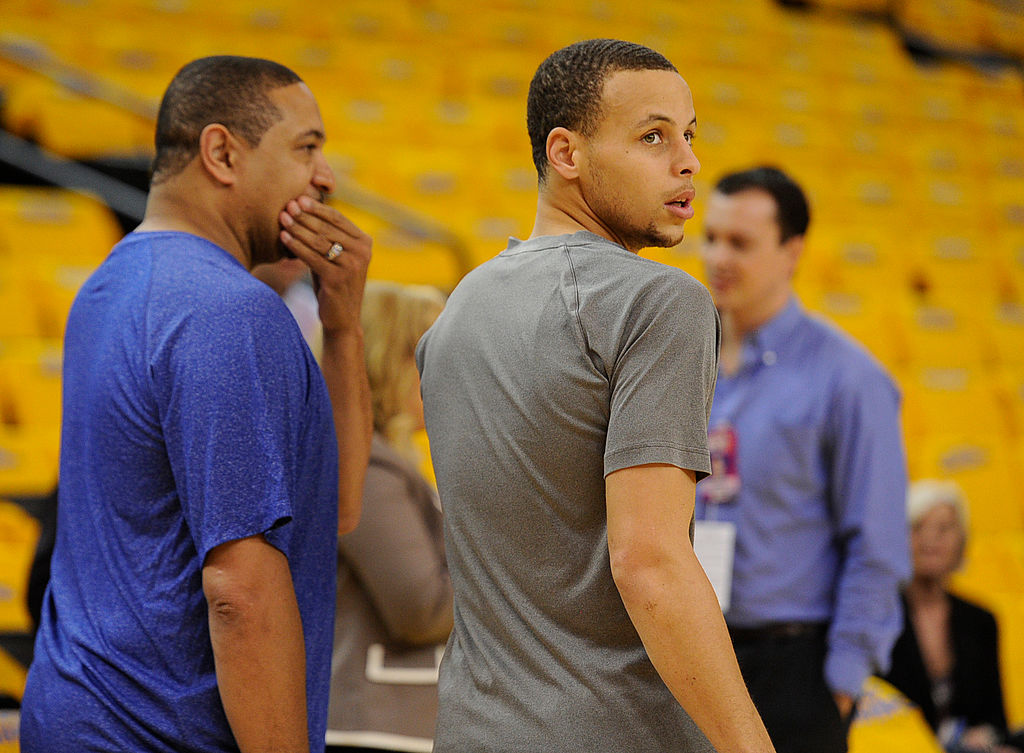 Steph Curry walking next to his coach Mark Jackson