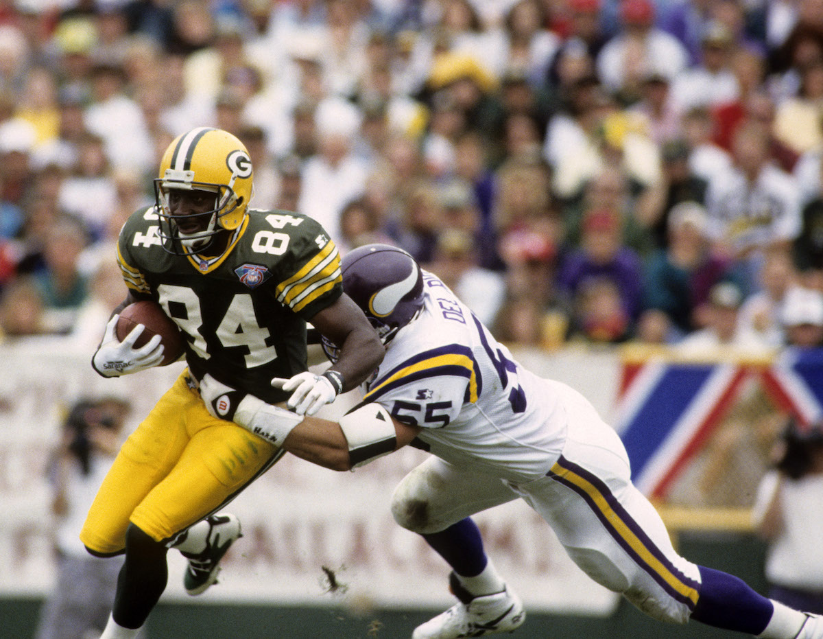 Sterling Sharpe fights for extra yardage