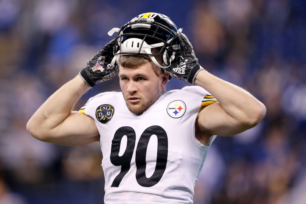 T.J. Watt putting his helmet back on during a game