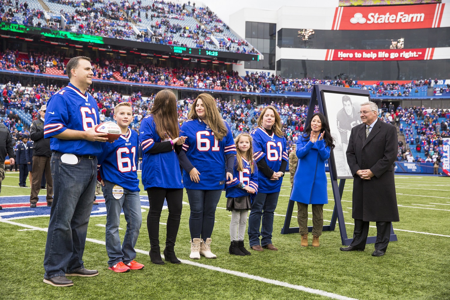 Buffalo Bills owners Kim and Terry Pegula, right, honor the family of Bob Kalsu during a ceremony at New Era Field on Nov. 27, 2016. | Brett Carlsen/Getty Images