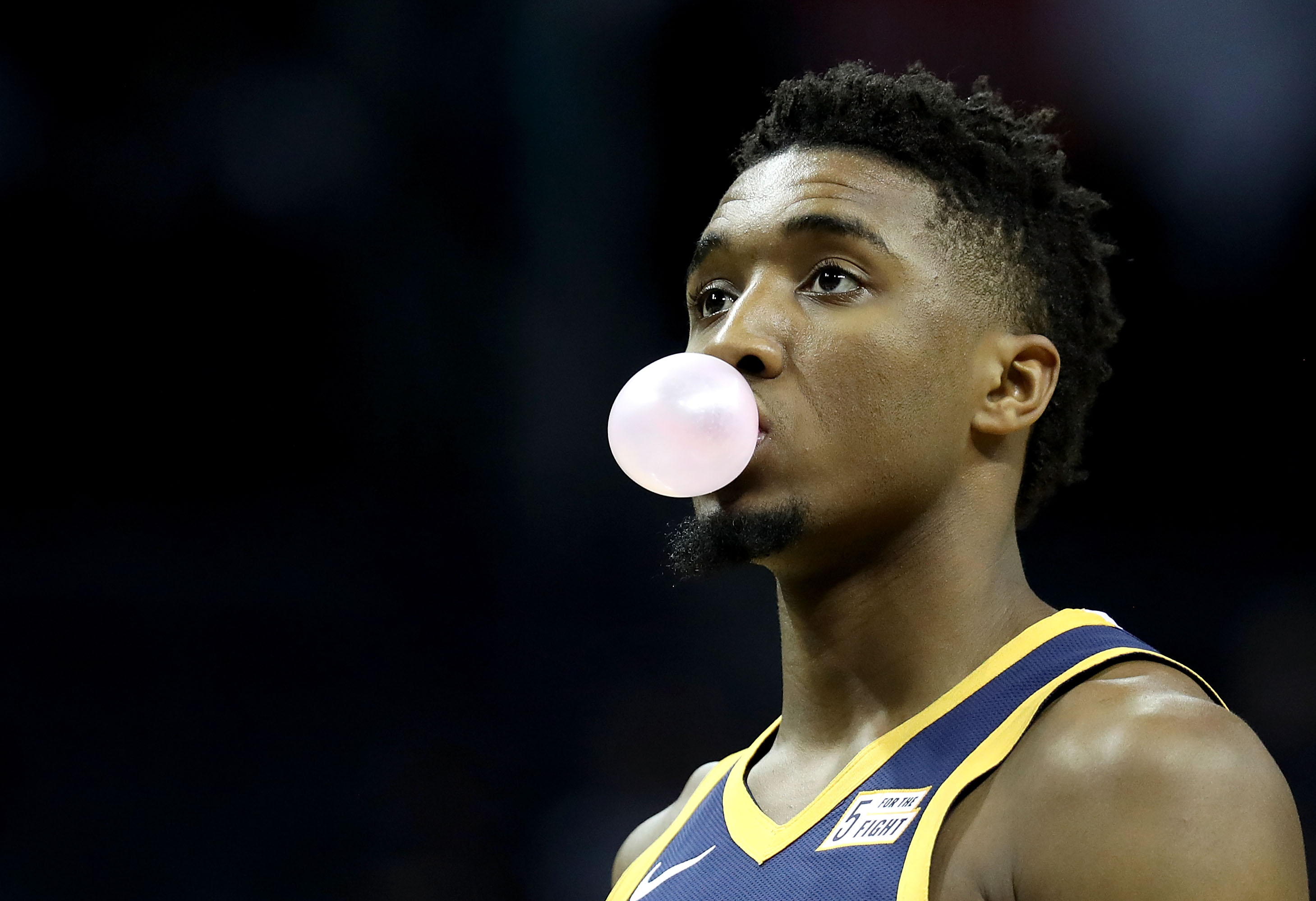 Donovan Mitchell chewing a piece of gum and blowing a bubble