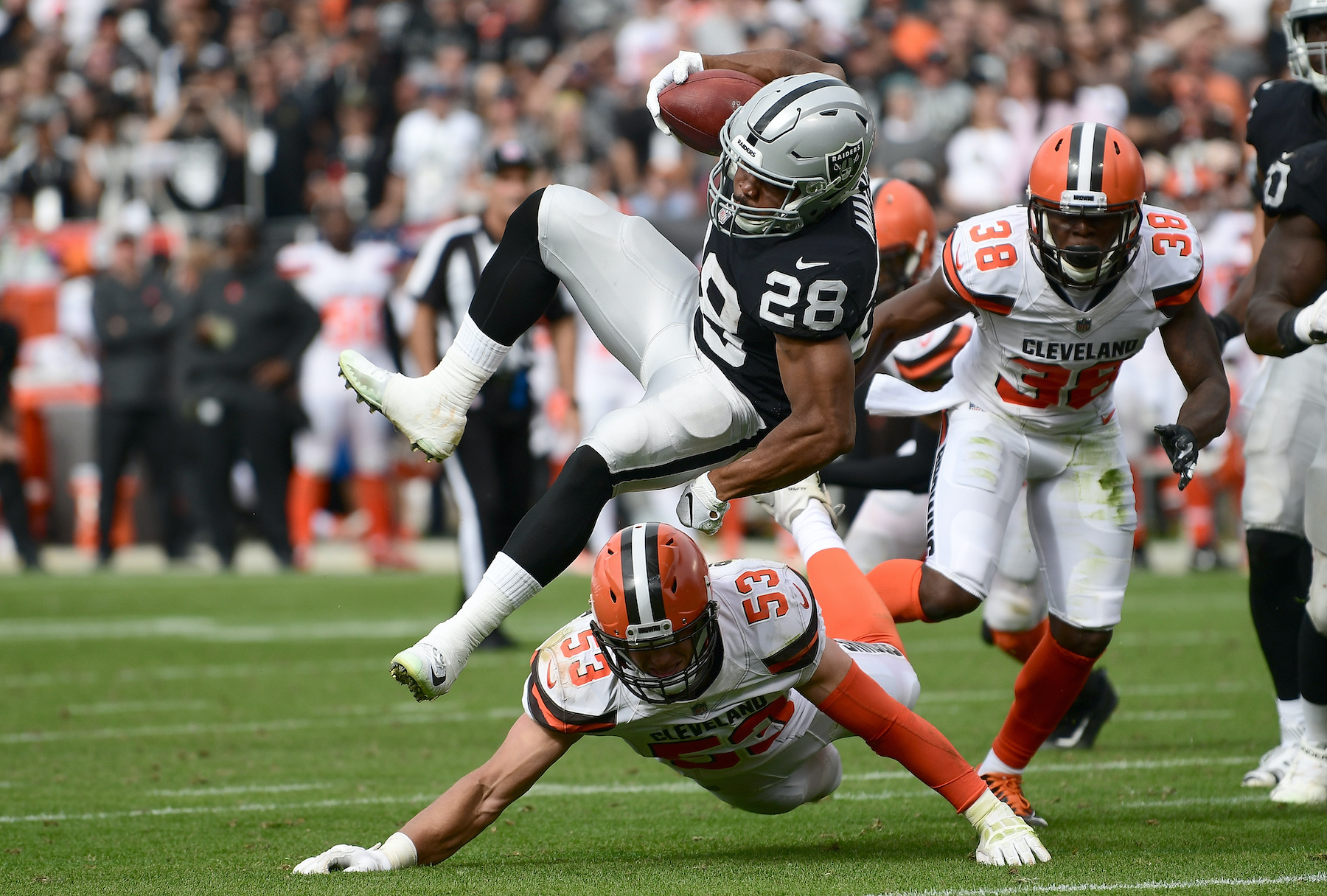 Doug Martin of the Oakland Raiders gets tackled by Joe Schobert of the Cleveland Browns in 2018