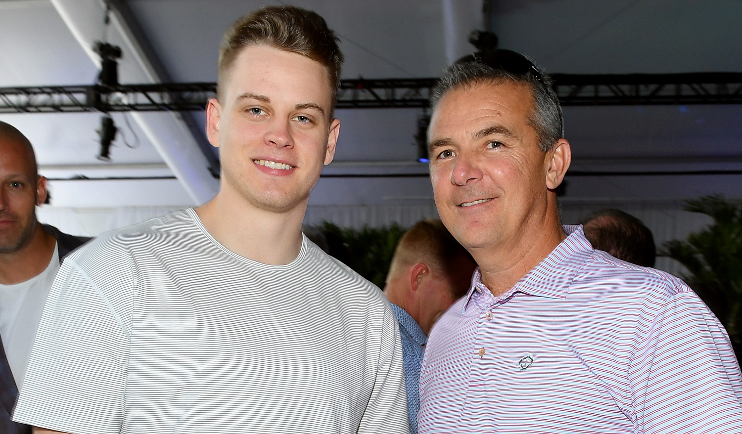 Joe Burrow, left, spent three seasons in Urban Meyer's Ohio State program before transferring to LSU. | Mike Coppola/Getty Images for Fanatics)