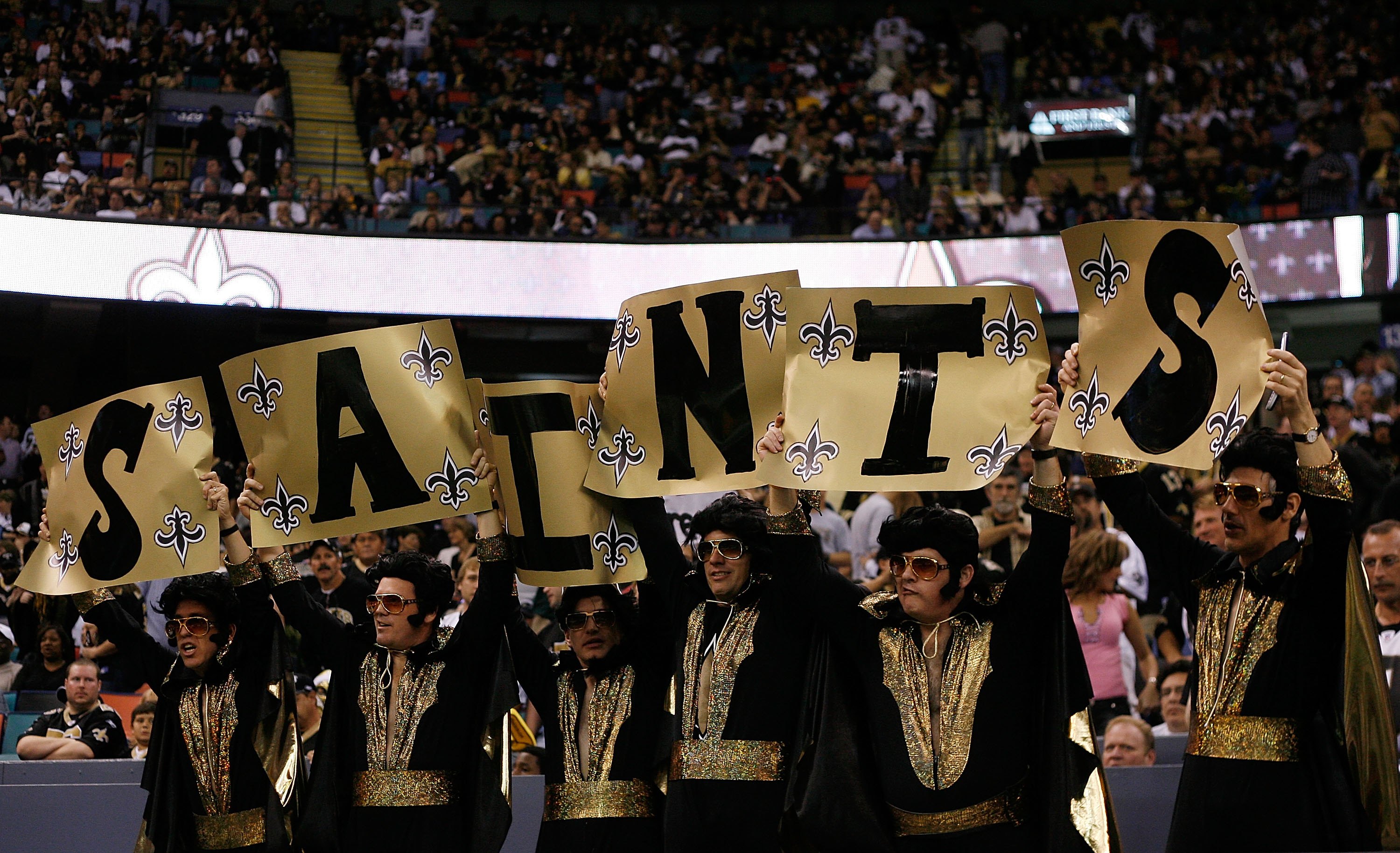 Saints fans holding up a sign during a game