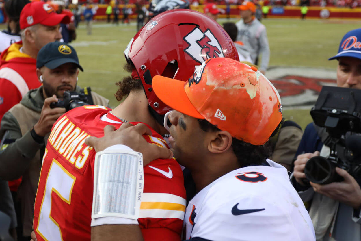 Patrick Mahomes (L) embraces Russell Wilson (R) after an NFL game.