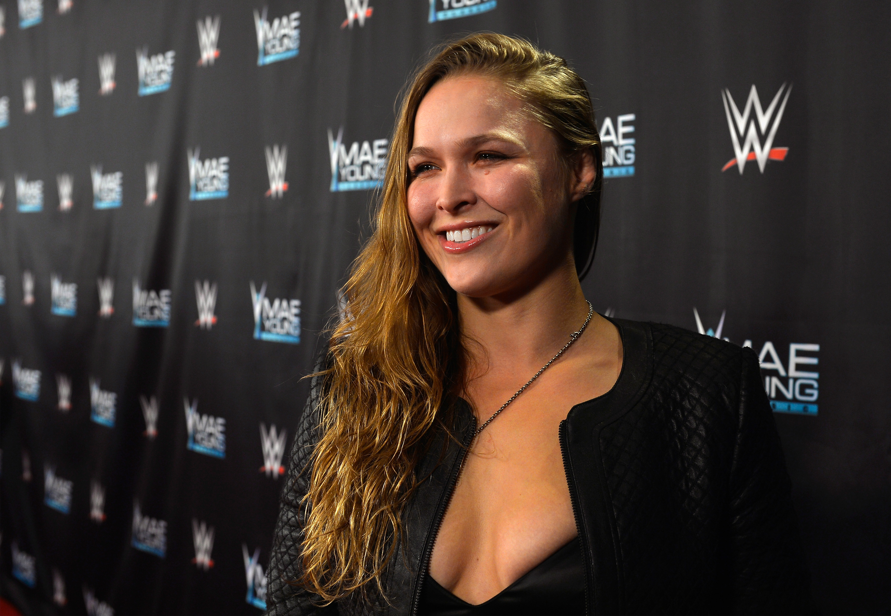 Ronda Rousey poses for a photo at a WWE event