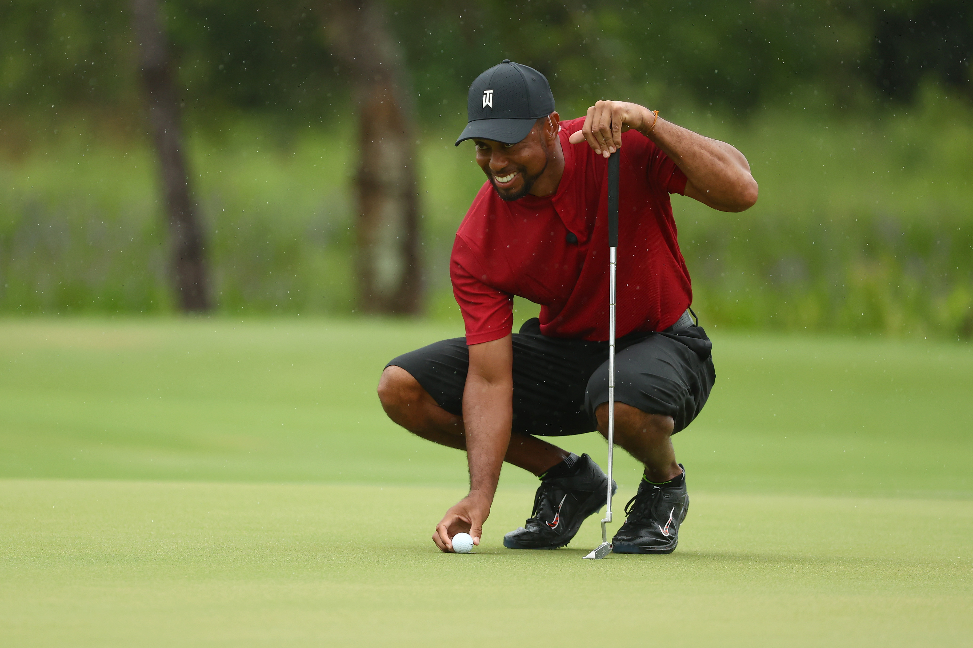 Tiger Woods lines up a putt