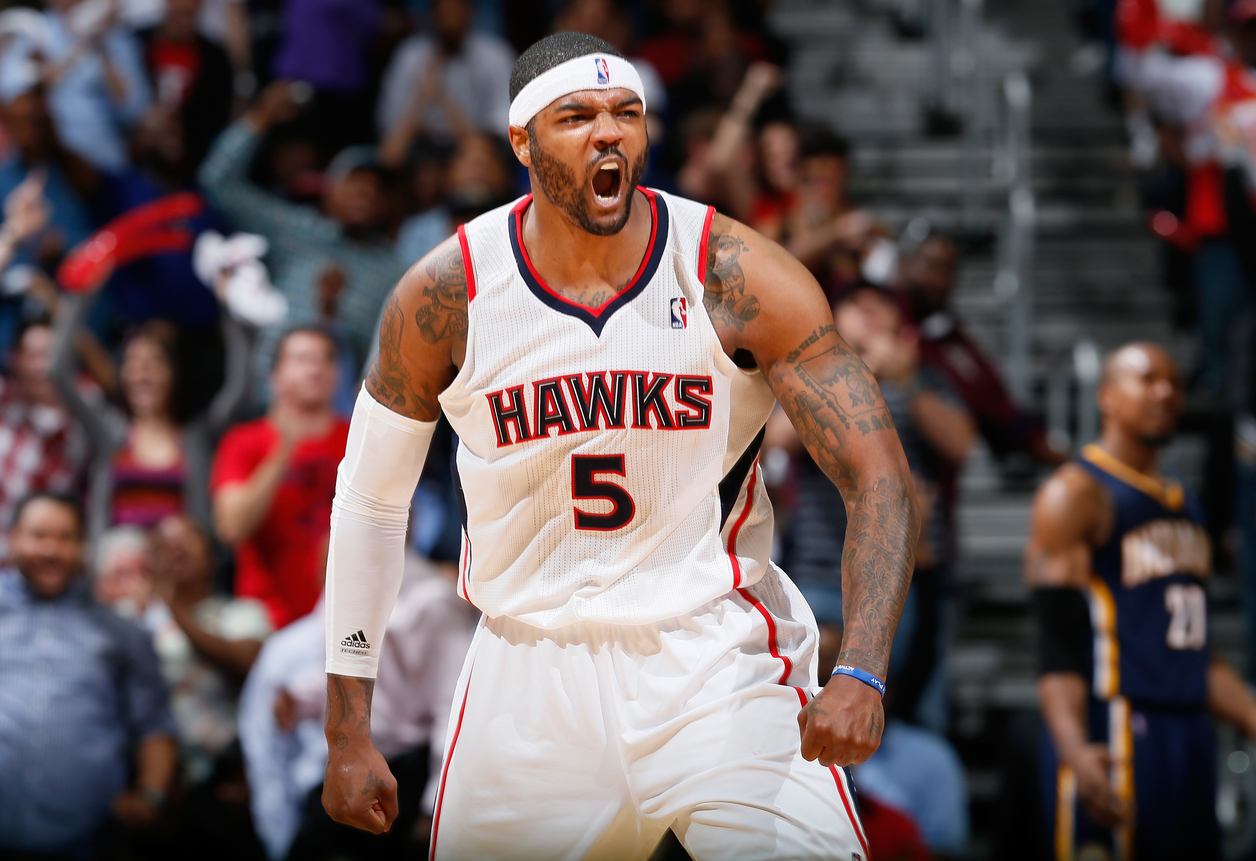 Josh Smith celebrates after making a shot during a Hawks game