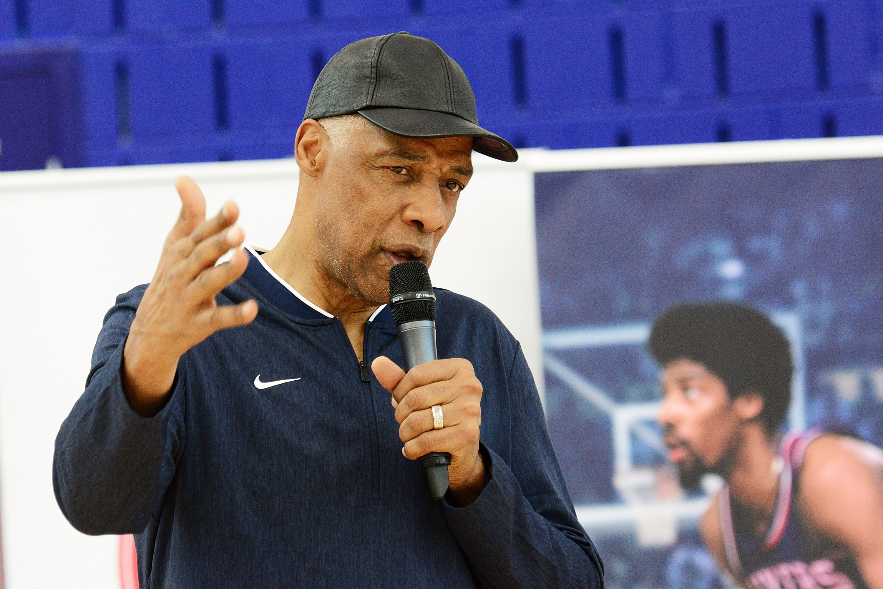 Julius Erving talking to kids at a basketball camp