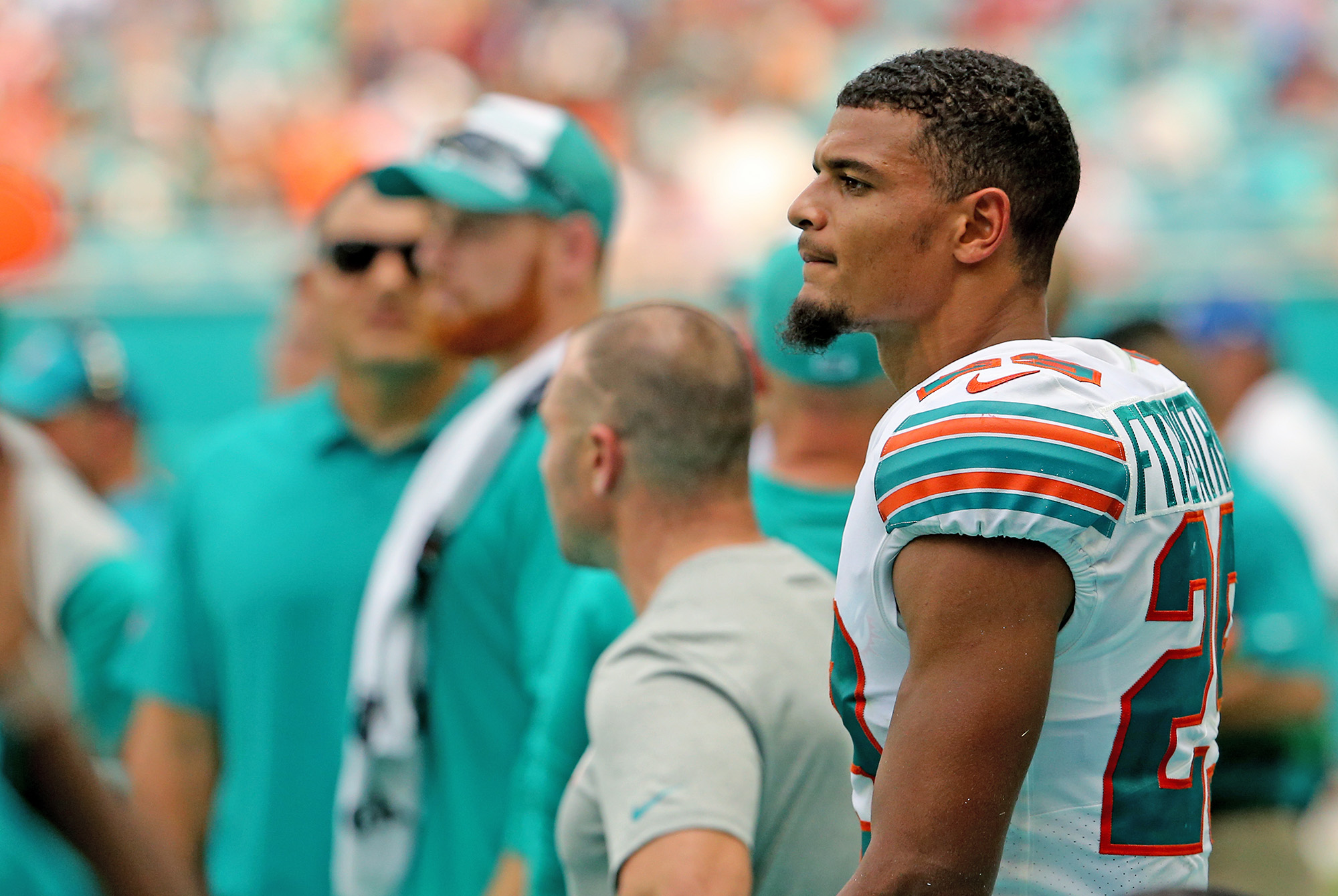 Minkah Fitzpatrick stands on the sideline during a Dolphins game