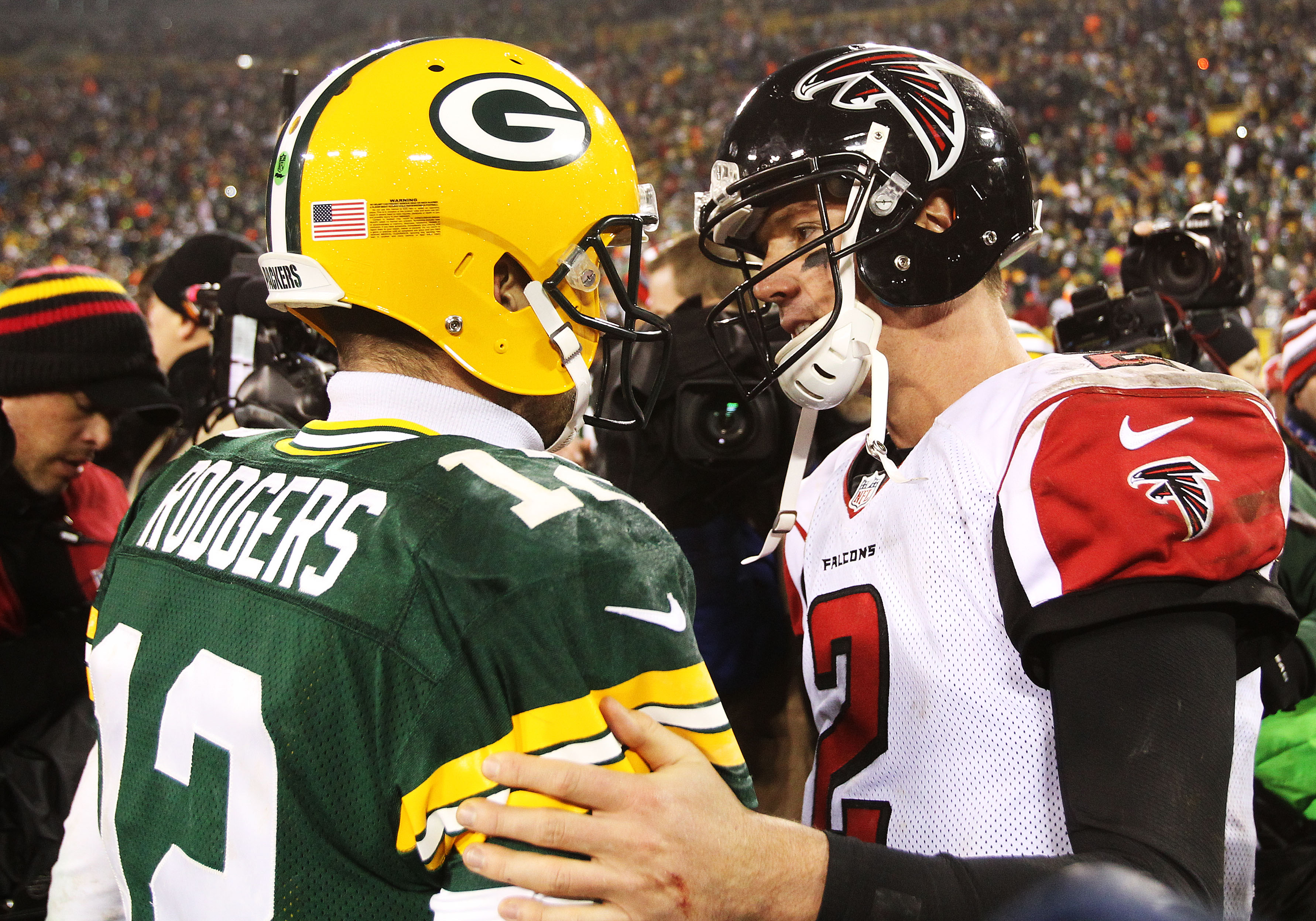 Matt Ryan and Aaron Rodgers talk at midfield after a game