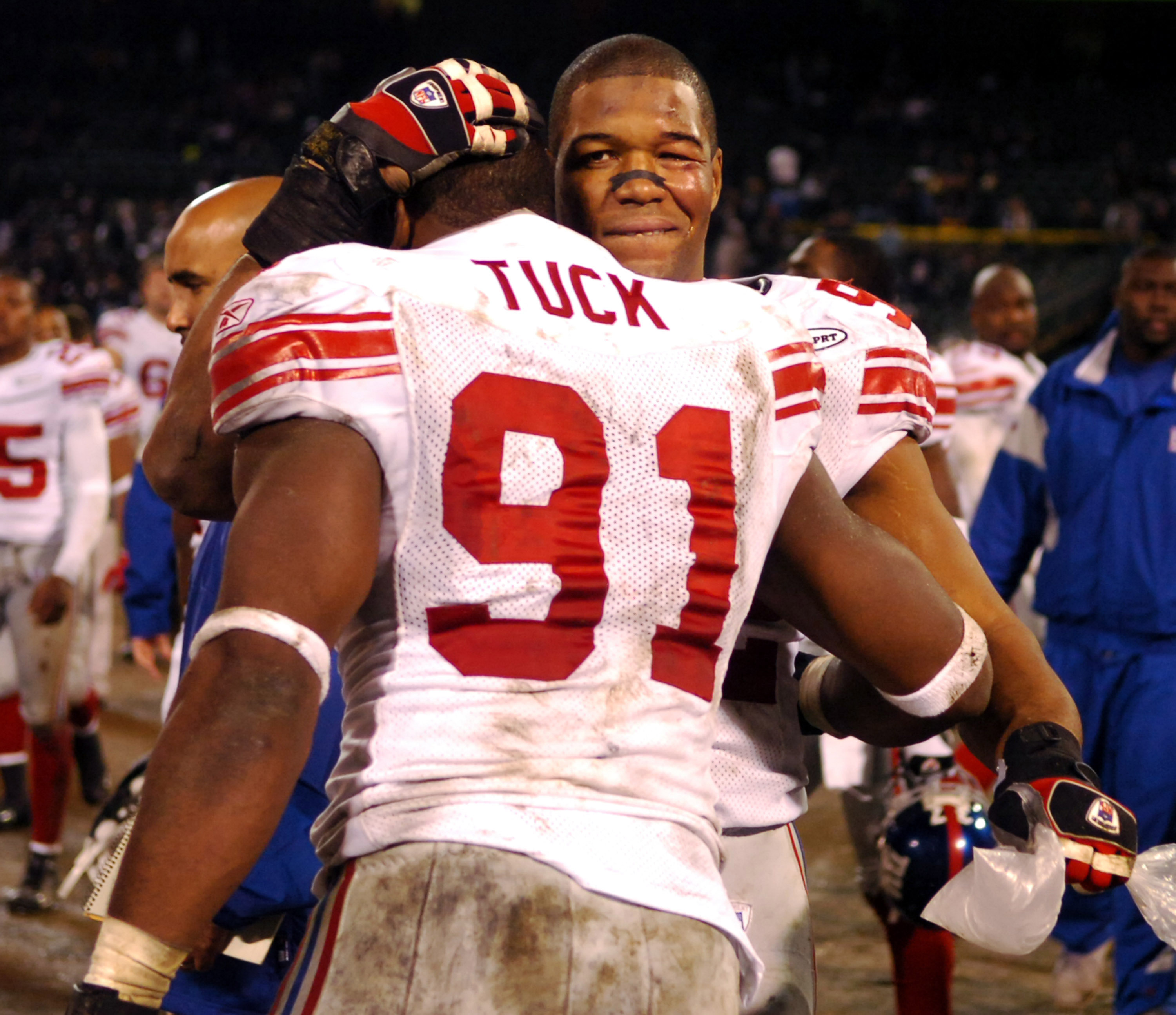 New York Giants defensive end Michael Strahan and Justin Tuck hug