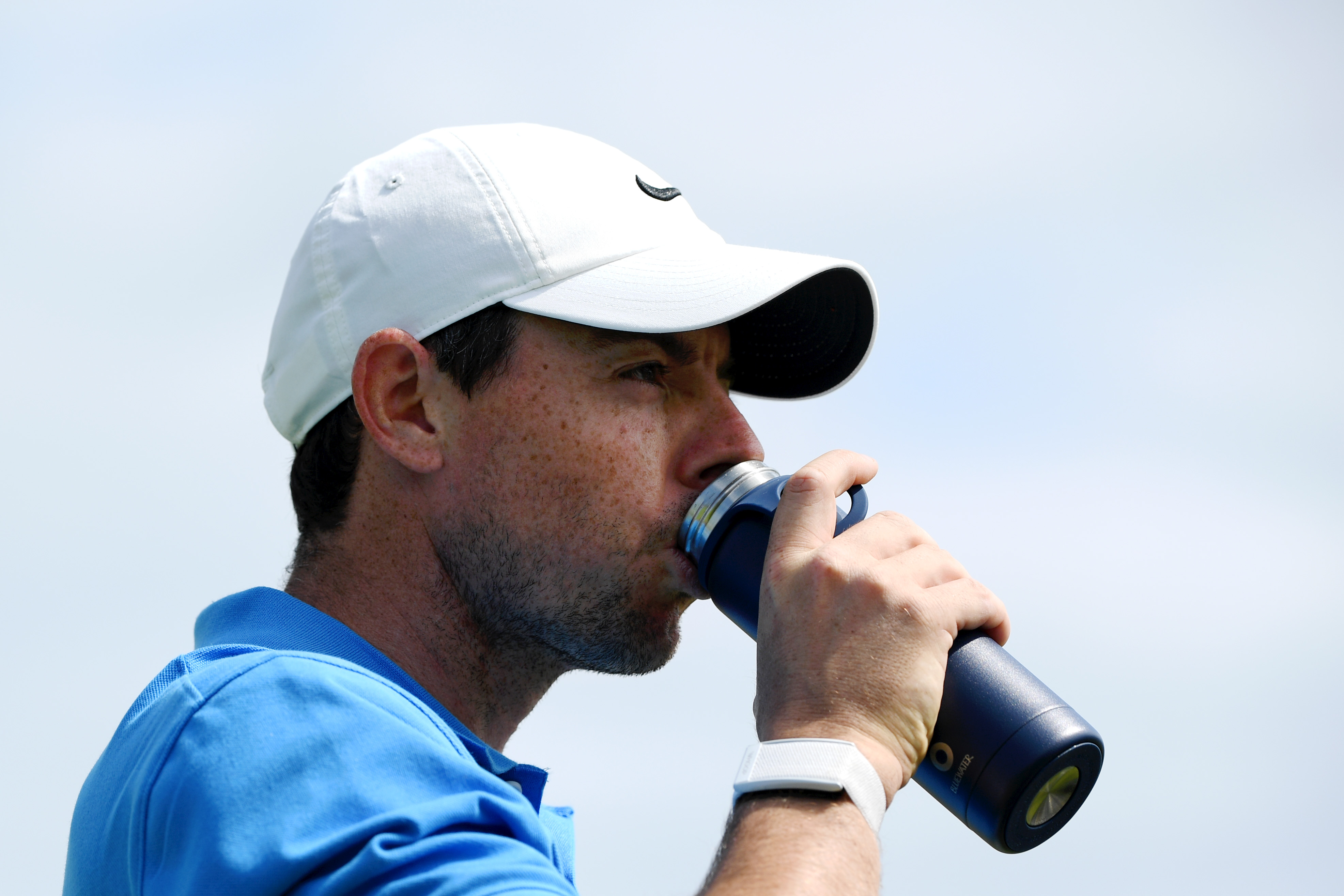 Rory McIlroy of Northern Ireland enjoys a drink