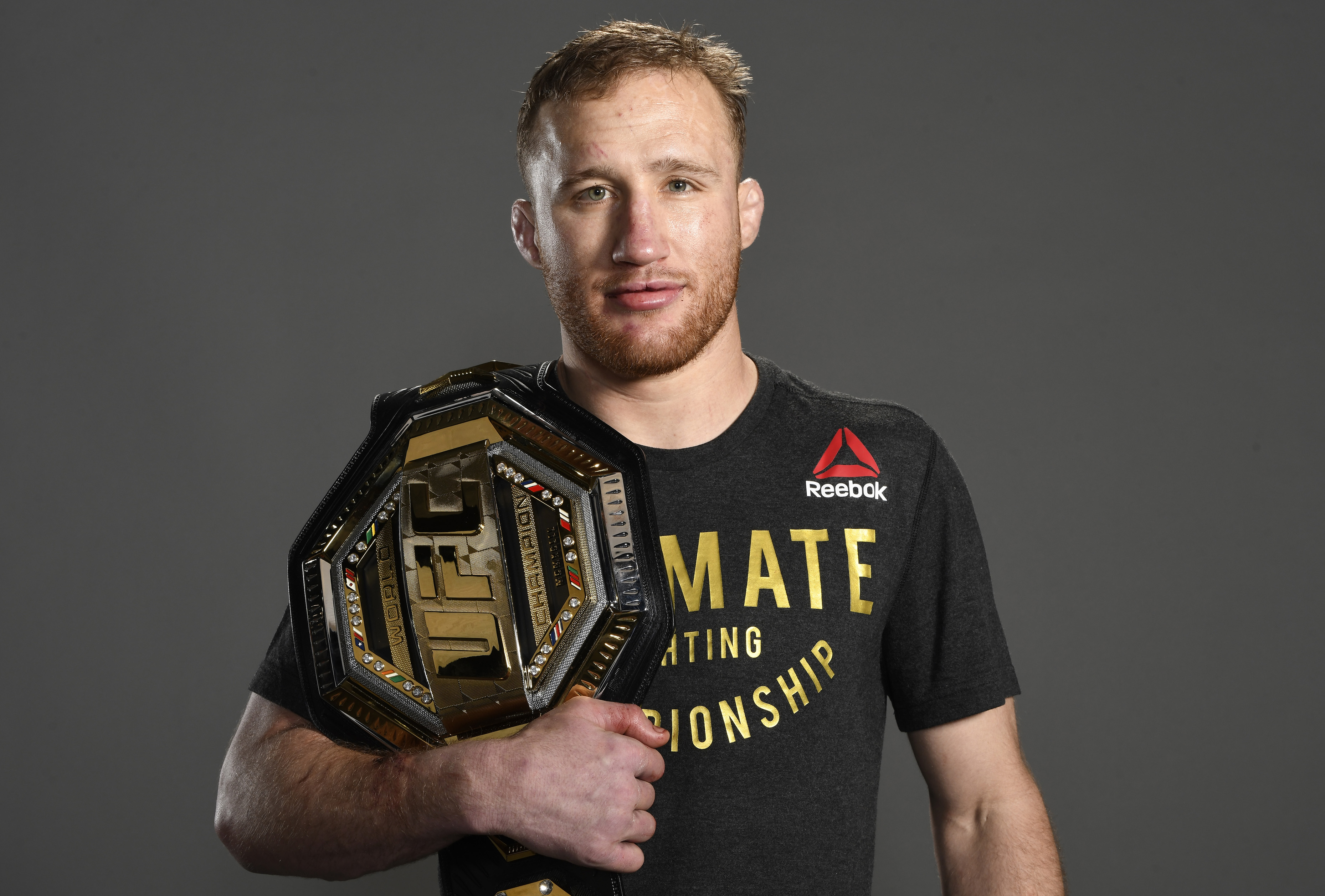 Justin Gaethje poses with his UFC Chapmionship belt. 