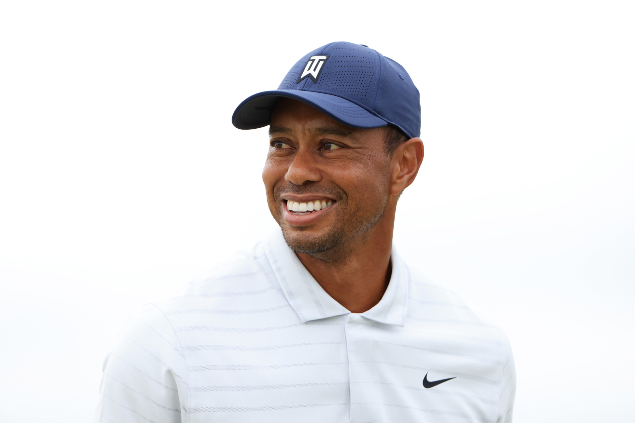 Tiger Woods smiles while playing in a golf event