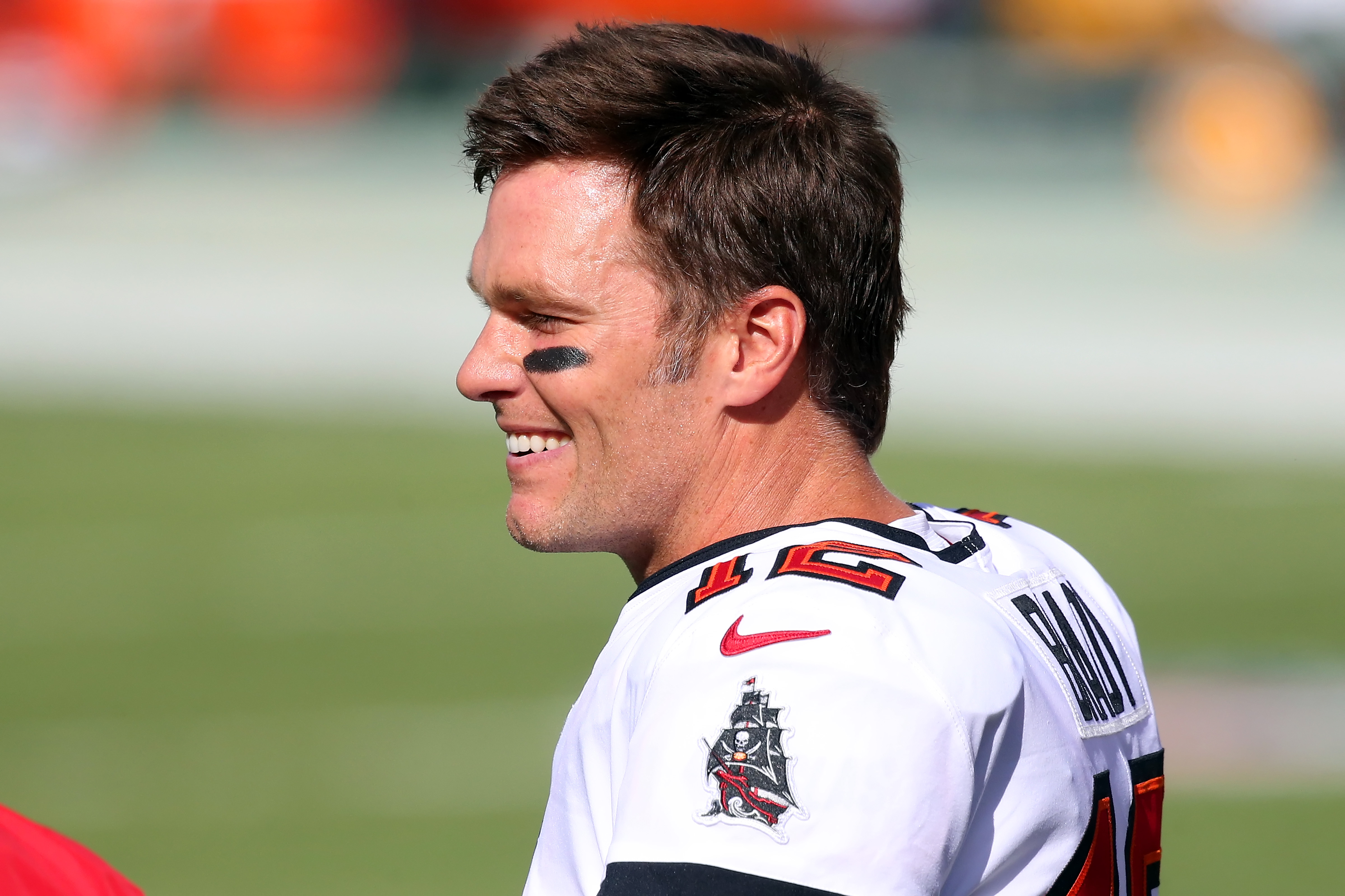 Tom Brady smiles during his warm up before a game