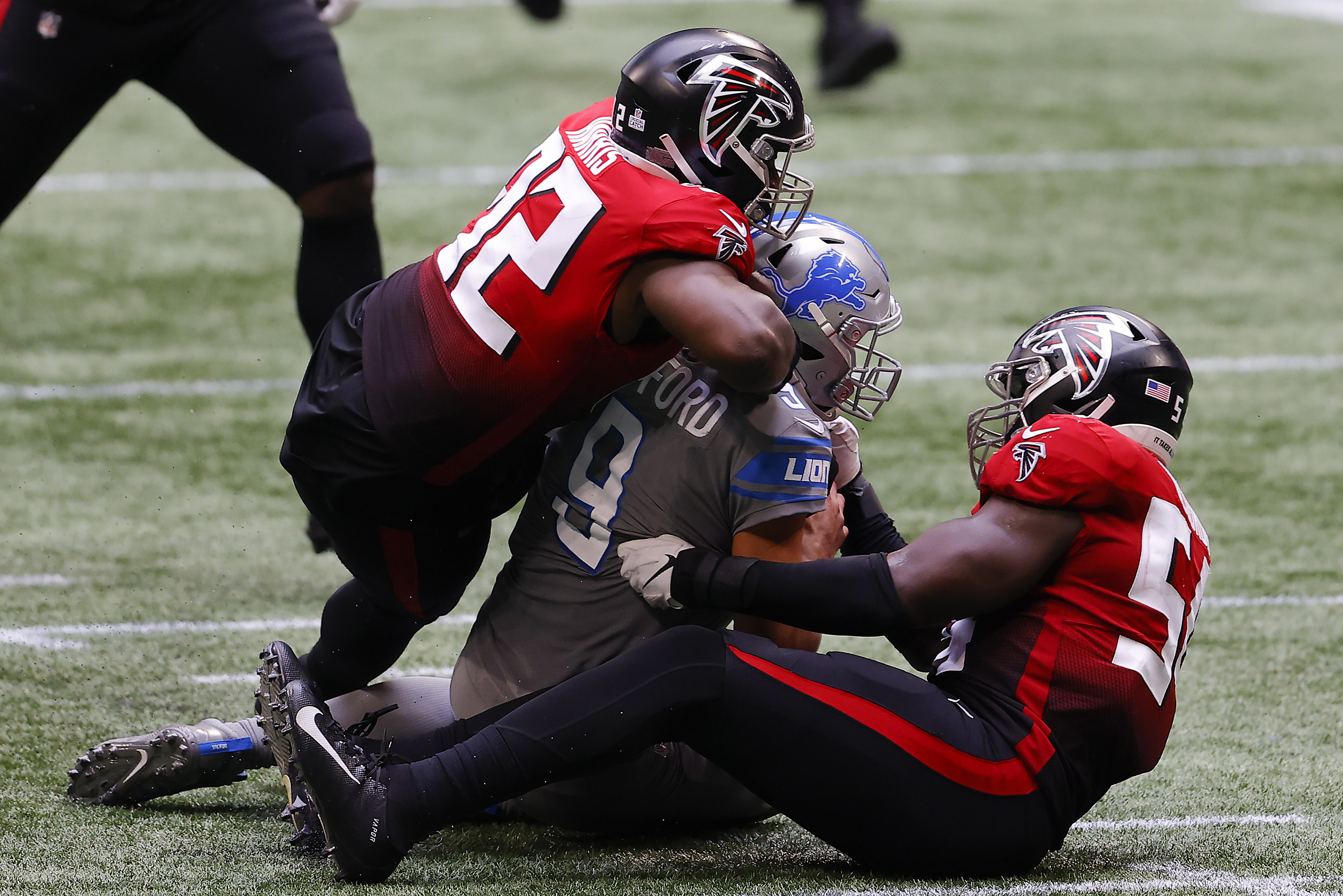 Matthew Stafford of the Detroit Lions is tackled by Charles Harris of the Atlanta Falcons