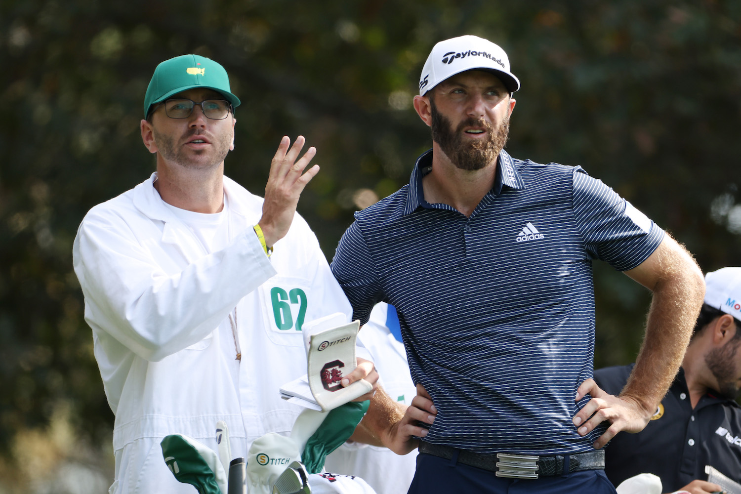 Dustin Johnson stands with caddie Austin Johnson