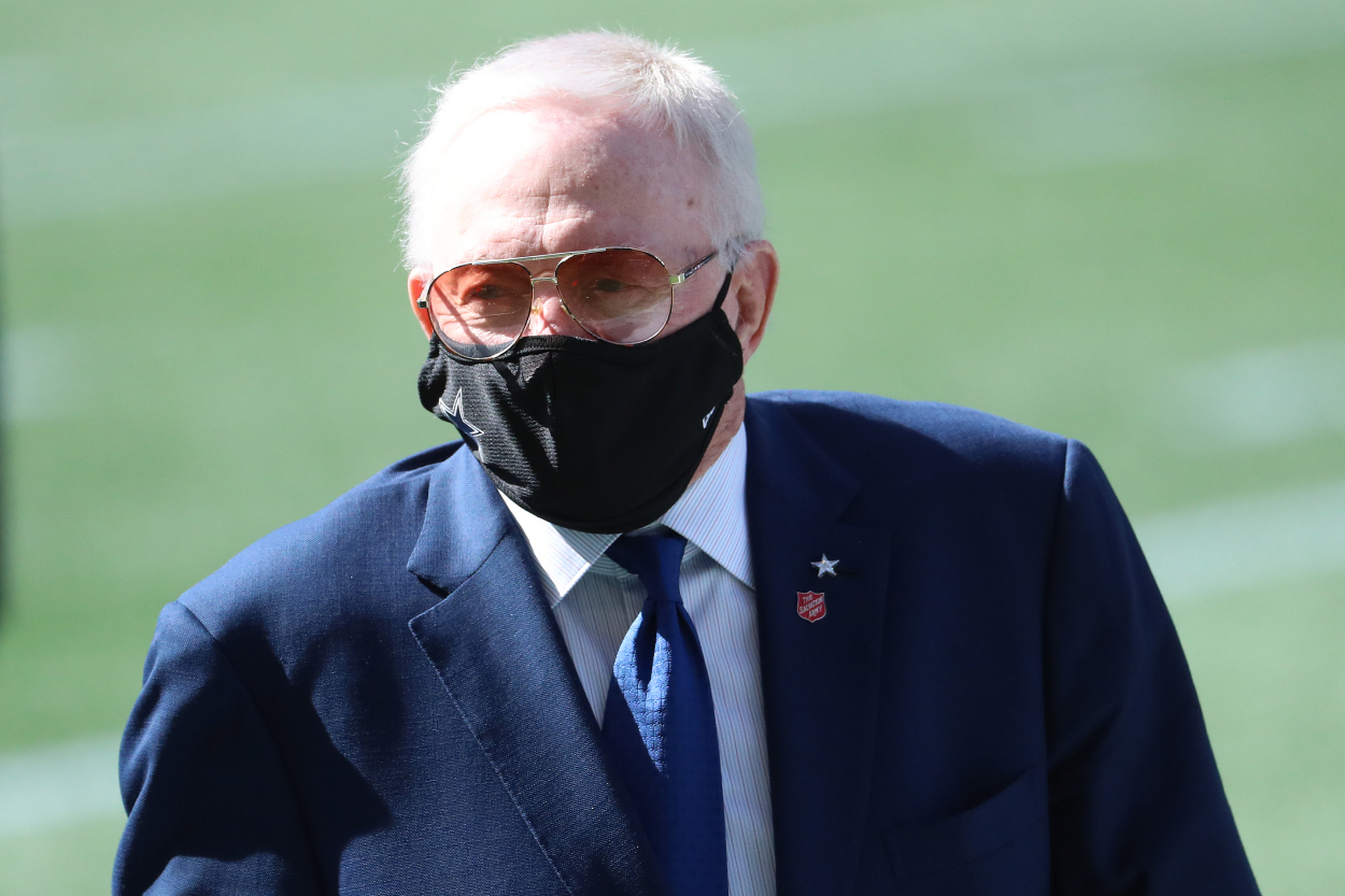 Jerry Jones watching a Cowboys game with a mask on
