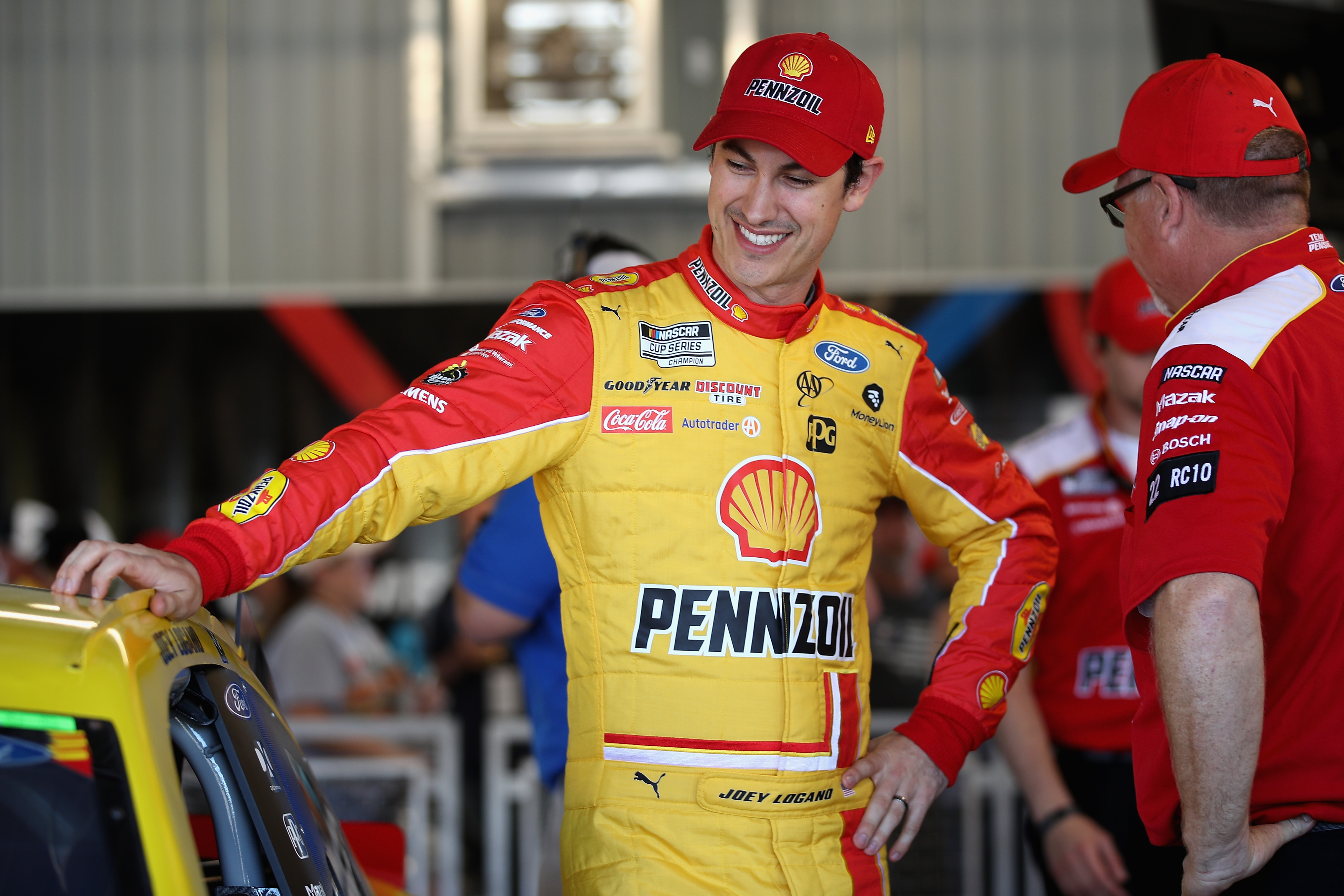 Joey Logano, driver of the #22 Shell Pennzoil Ford, stands in the garage during practice