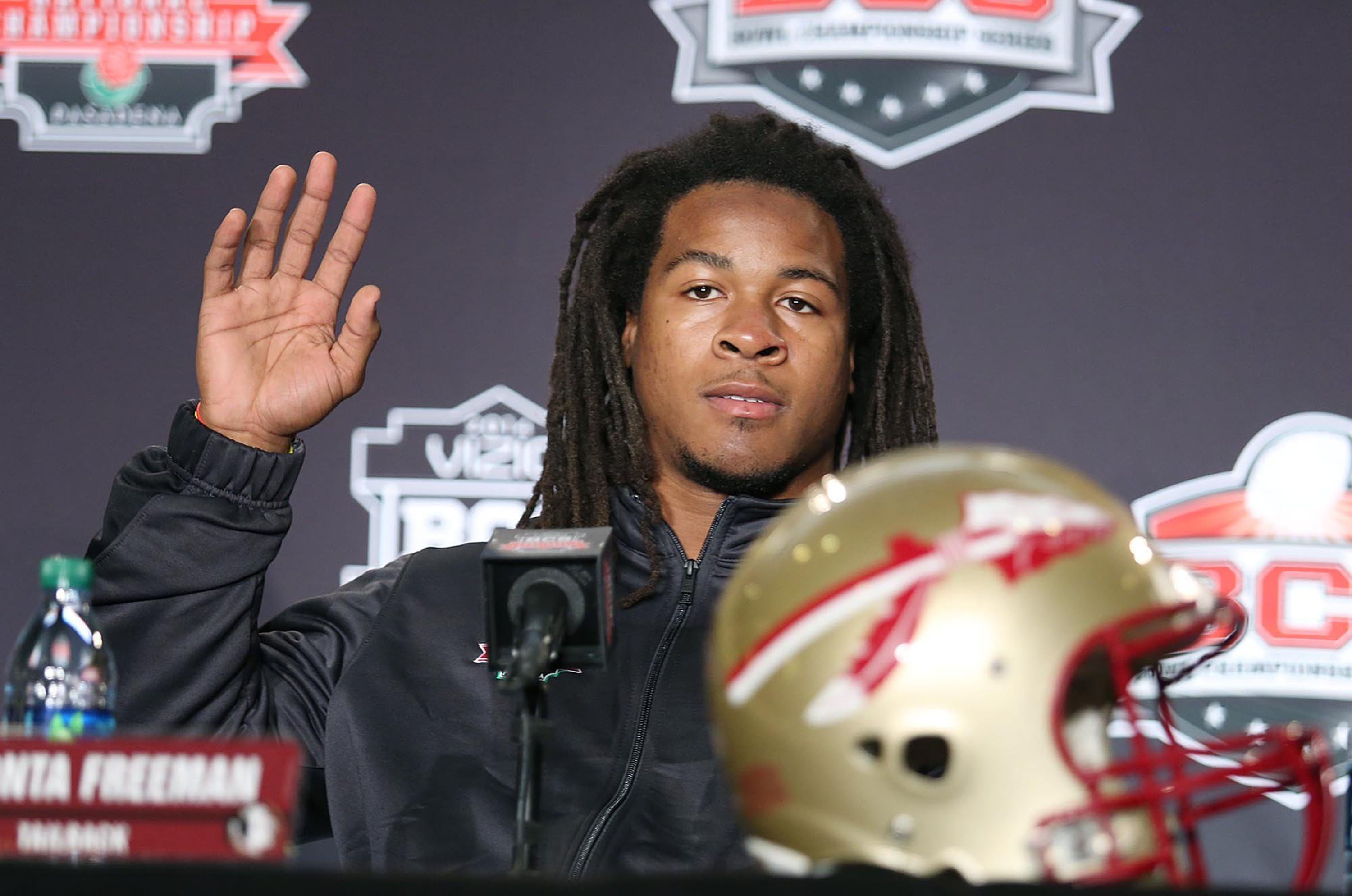 Running back Devonta Freeman waves during a BCS National Championship game news conference in 2014
