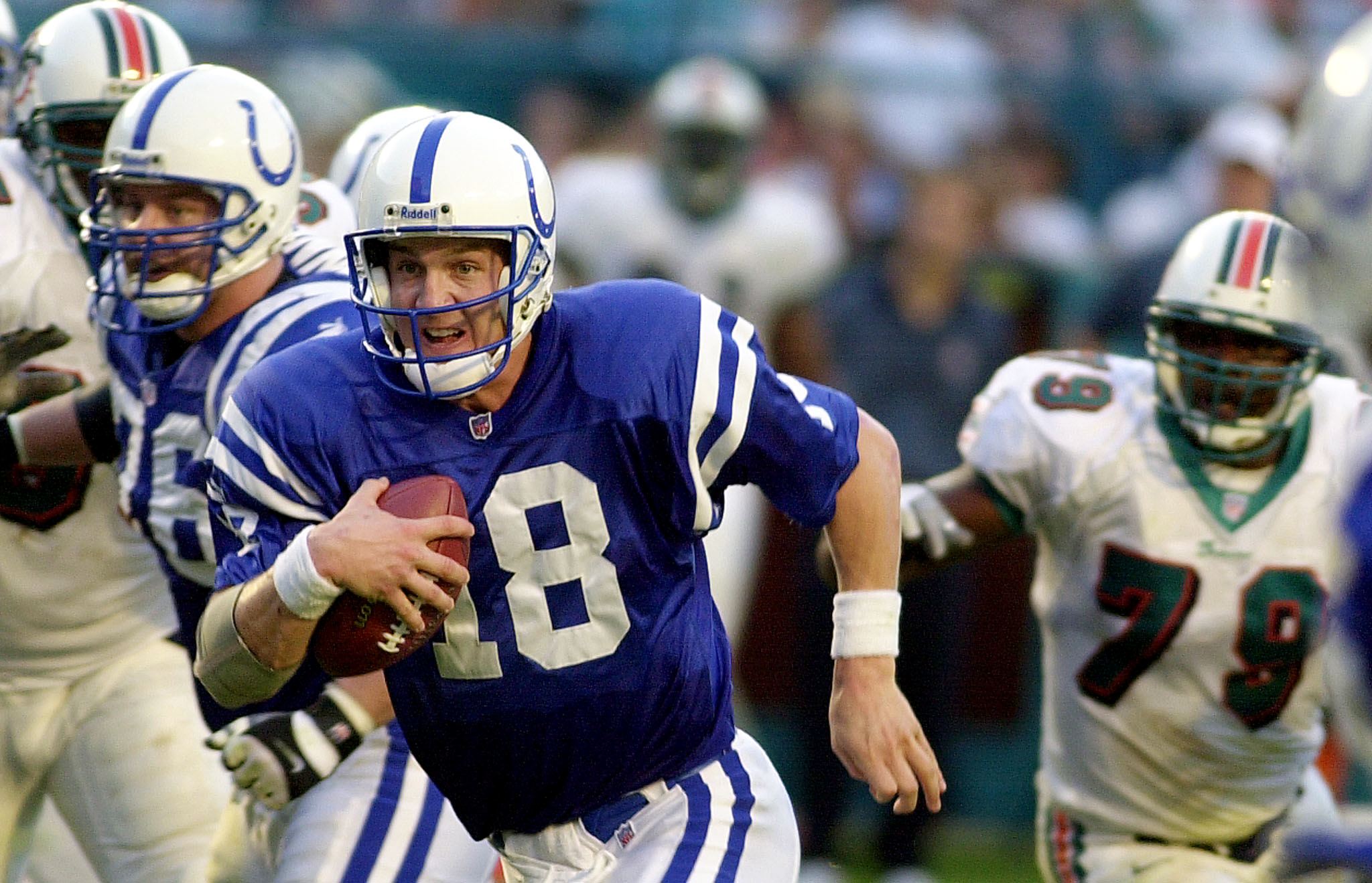 Peyton Manning runs with the football during a Colts game