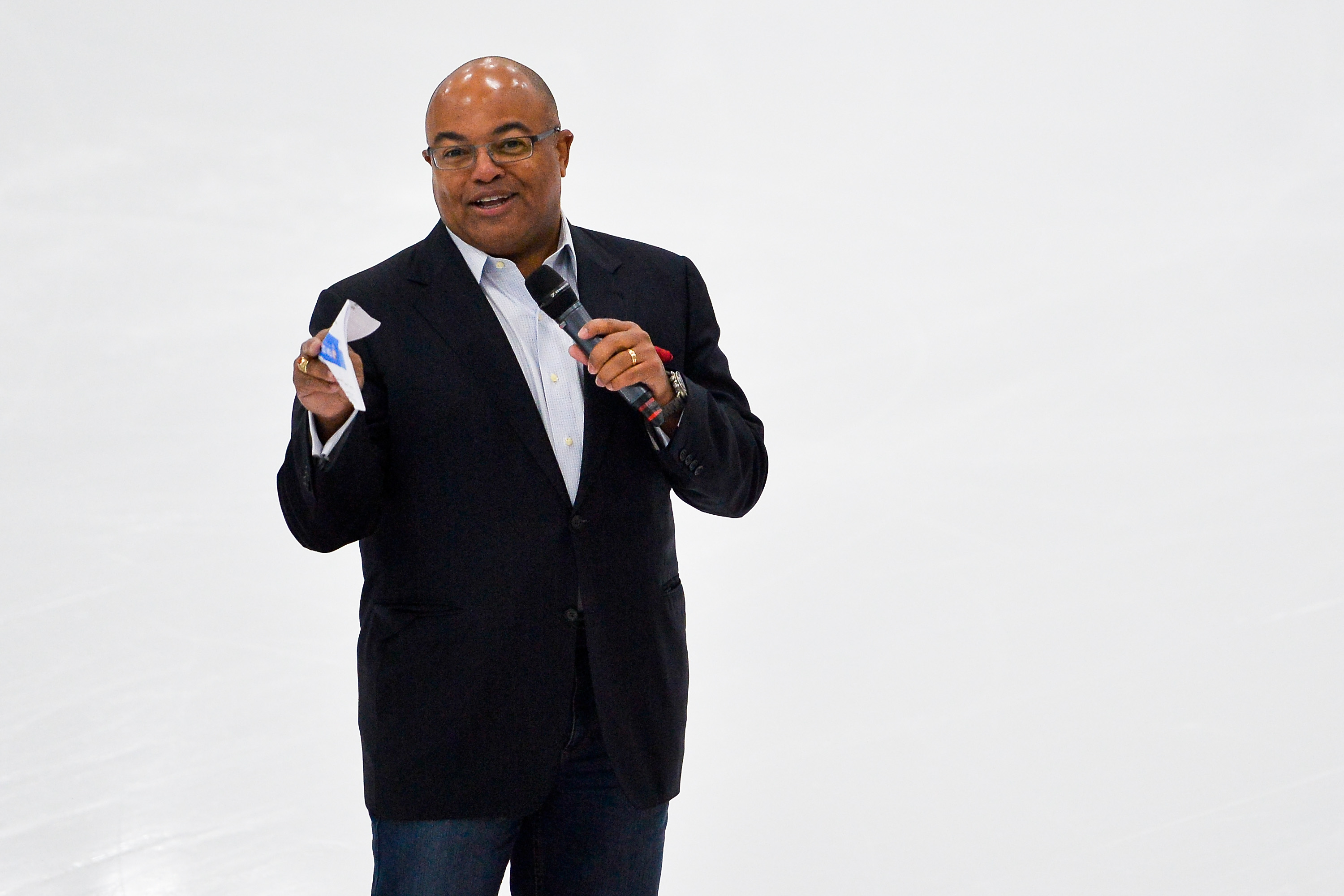 Why did Mike Tirico always carry a spoon while growing up?